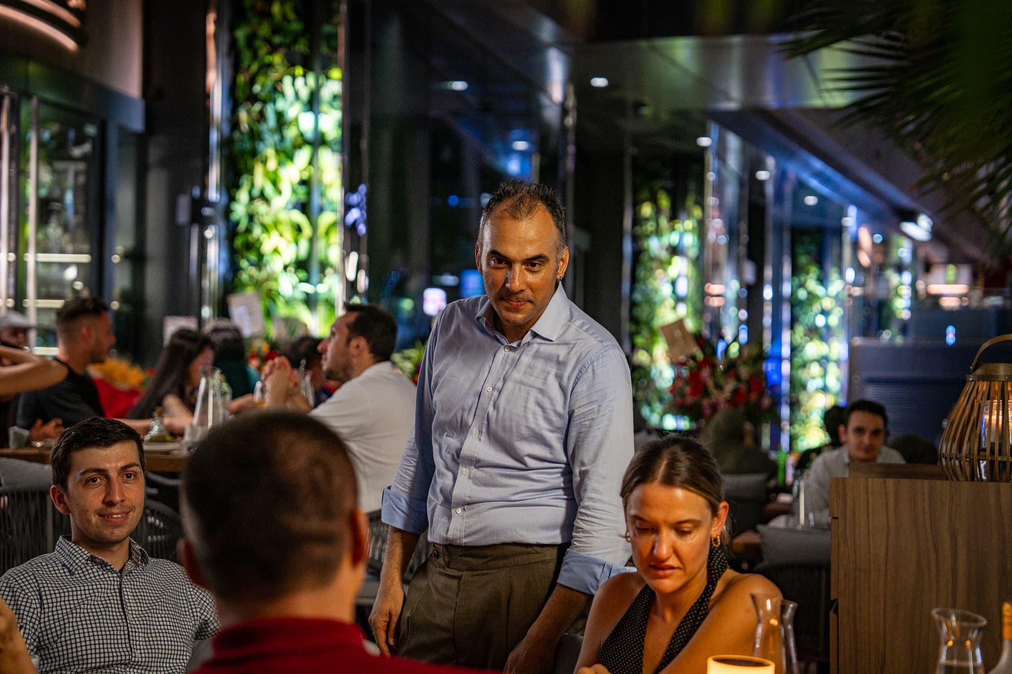 Guests dining together during an evening event at Pera